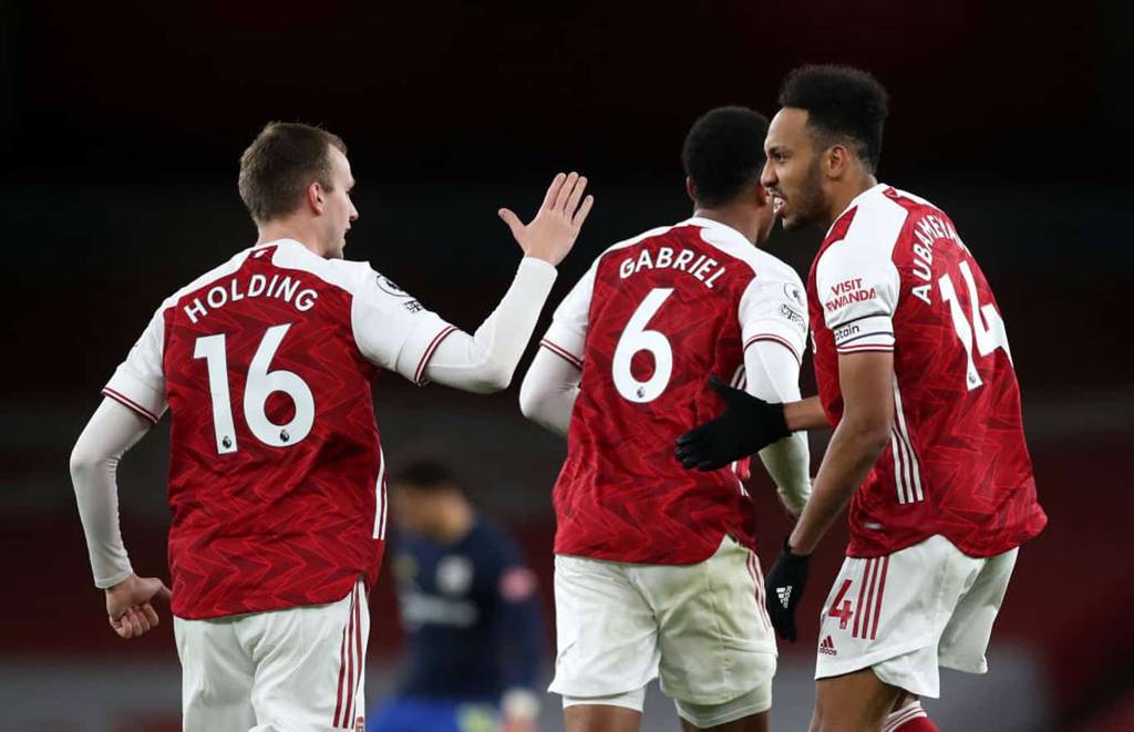 LONDON, ENGLAND - DECEMBER 16: Pierre-Emerick Aubameyang of Arsenal celebrates with teammate Rob Holding after scoring their team's first goal during the Premier League match between Arsenal and Southampton at Emirates Stadium on December 16, 2020 in London, England. The match will be played without fans, behind closed doors as a Covid-19 precaution. (Photo by Peter Cziborra - Pool/Getty Images)