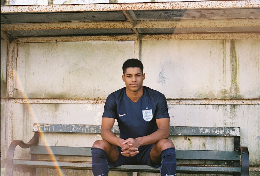 Marcus Rashford models the new England away kit