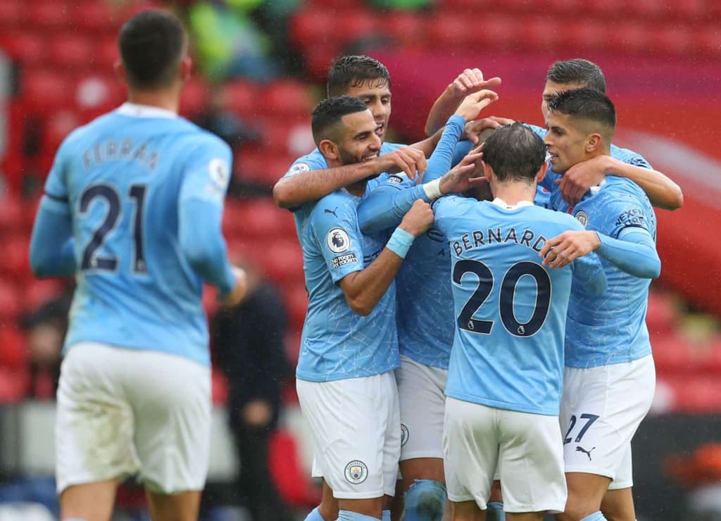 SHEFFIELD, ENGLAND - OCTOBER 31: Kyle Walker of Manchester City celebrates with teammates after scoring his team's first goal during the Premier League match between Sheffield United and Manchester City at Bramall Lane on October 31, 2020 in Sheffield, England. Sporting stadiums around the UK remain under strict restrictions due to the Coronavirus Pandemic as Government social distancing laws prohibit fans inside venues resulting in games being played behind closed doors. (Photo by Catherine Ivill/Getty Images)