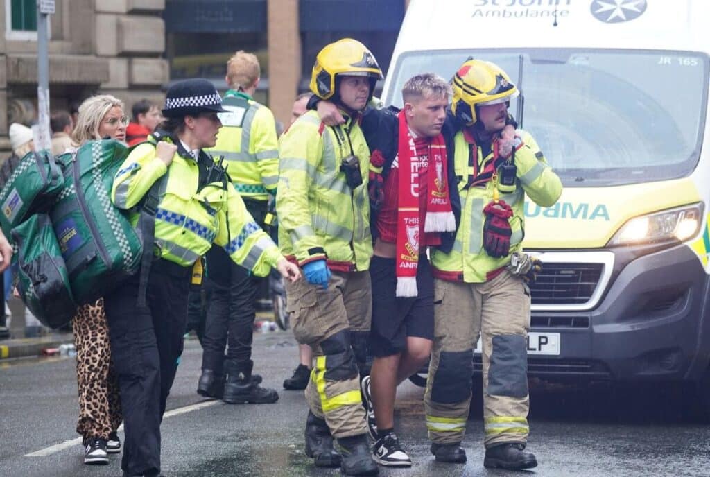 A Liverpool fan is helped by emergency services
