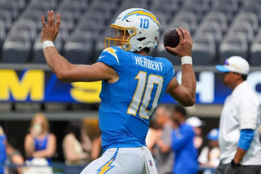 Los Angeles Chargers quarterback Justin Herbert winding up to throw a football.