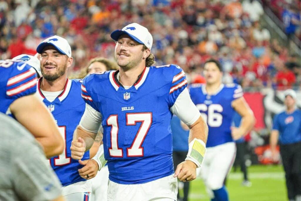 Buffalo Bills quarterback Josh Allen jogs off the field with his teammates during a preseason game.