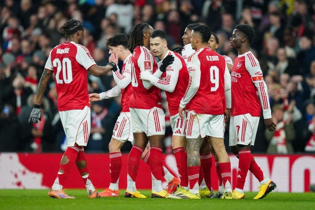 Arsenal celebrate a goal against Wigan