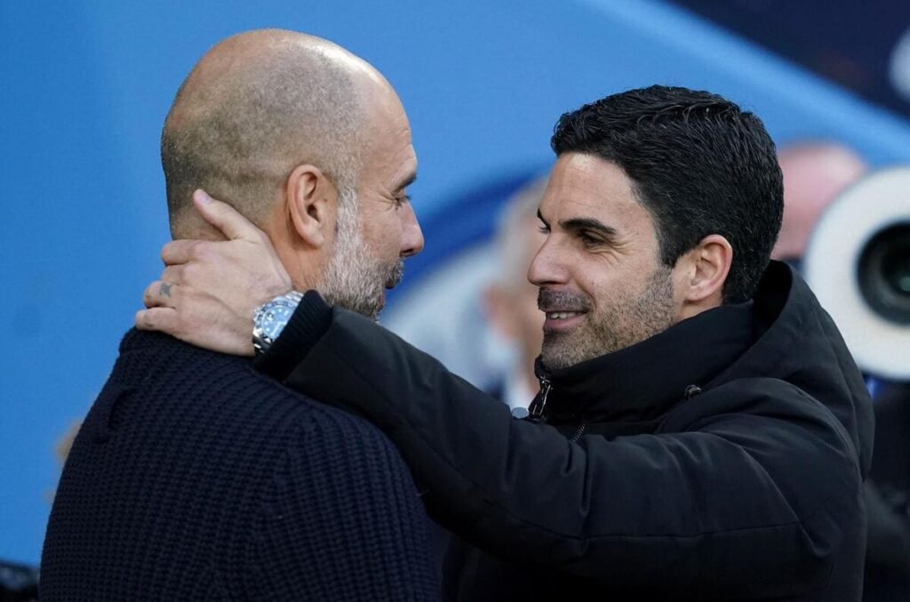Manchester City boss Pep Guardiola and Arsenal head coach Mikel Arteta embrace