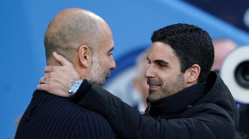 Manchester City boss Pep Guardiola and Arsenal head coach Mikel Arteta embrace