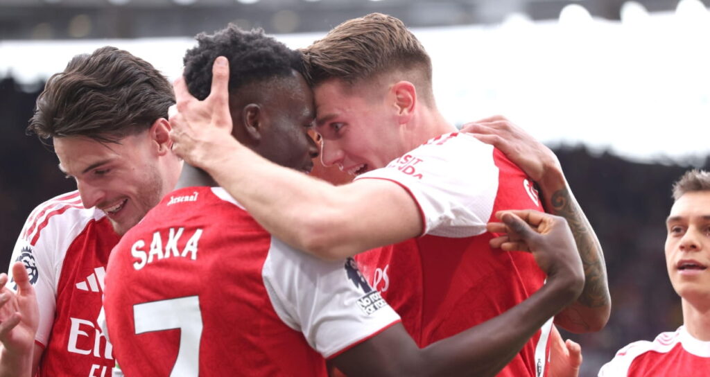 Arsenal players celebrate scoring against Fulham