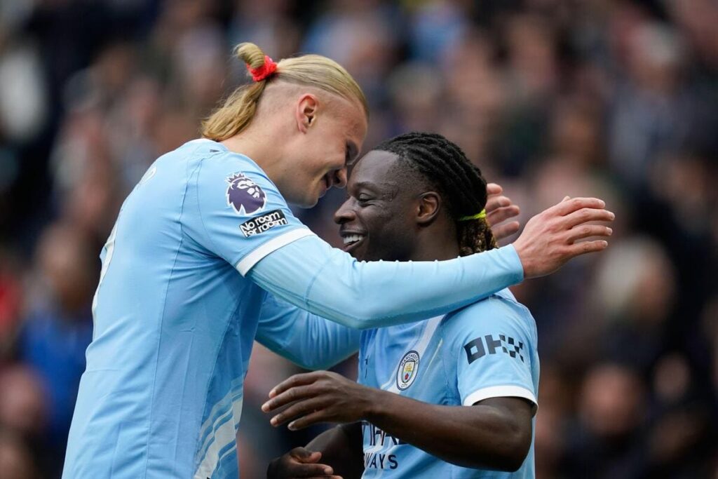 Jeremy Doku and Erling Haaland of Manchester City