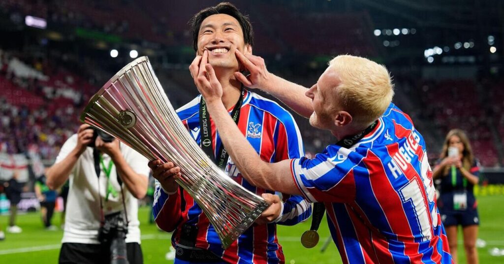 Crystal Palace's Daichi Kamada and Will Hughes celebrate with the UEFA Europa Conference League Trophy after winning the Final against Rayo Vallecano