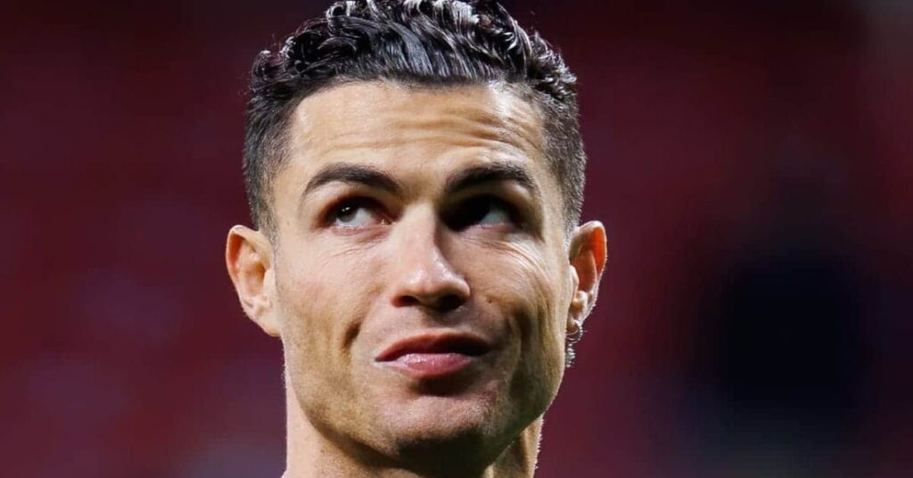 Cristiano Ronaldo playing football while looking upwards to his right in a stadium