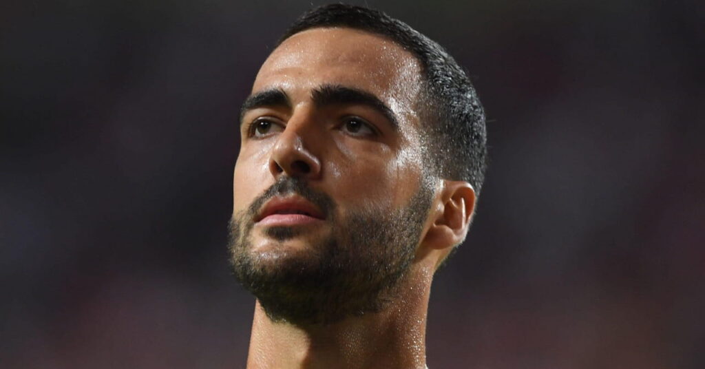 A photo of footballer Mikel Merino looking to his right while standing on a pitch playing for the Spain national football team