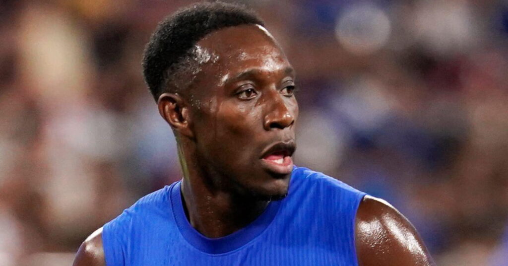 Footballer Danny Welbeck looking to his left while running in a blues sleeveless shirt and playing for Premier League team Chelsea Football Club