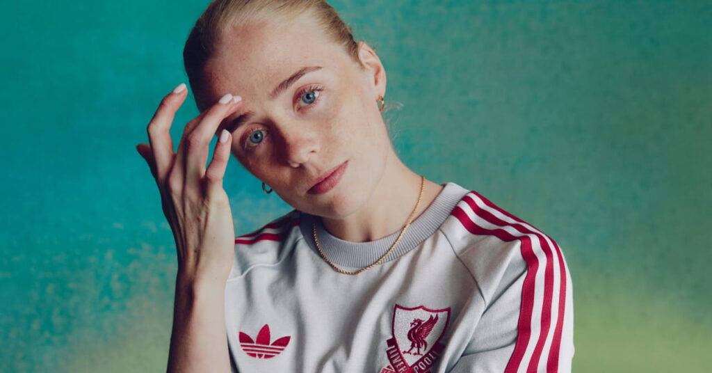 Footballer Grace Fisk wearing the Adidas Liverpool Football Club Premier League away kit of white with red trim