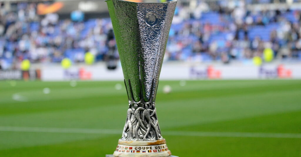 The angular silver trophy of European football competition the UEFA Europa League on a green football pitch