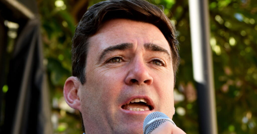 British Prime Minister Andy Burnham speaking in to a microphone outside as the Labour politician gives a speech