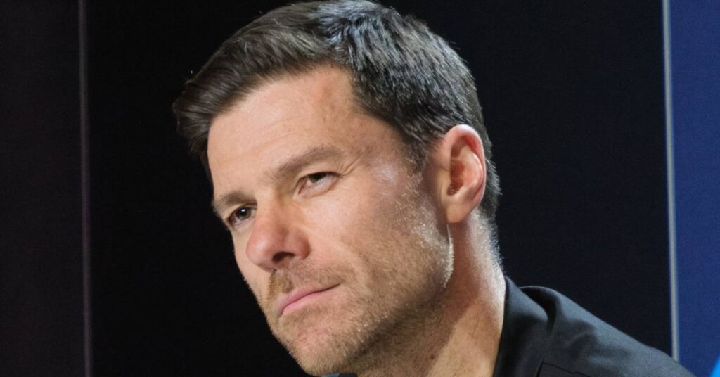 Football manager Xabi Alonso looking to his right in a stadium in his role as head coach of Premier League team Chelsea Football Club