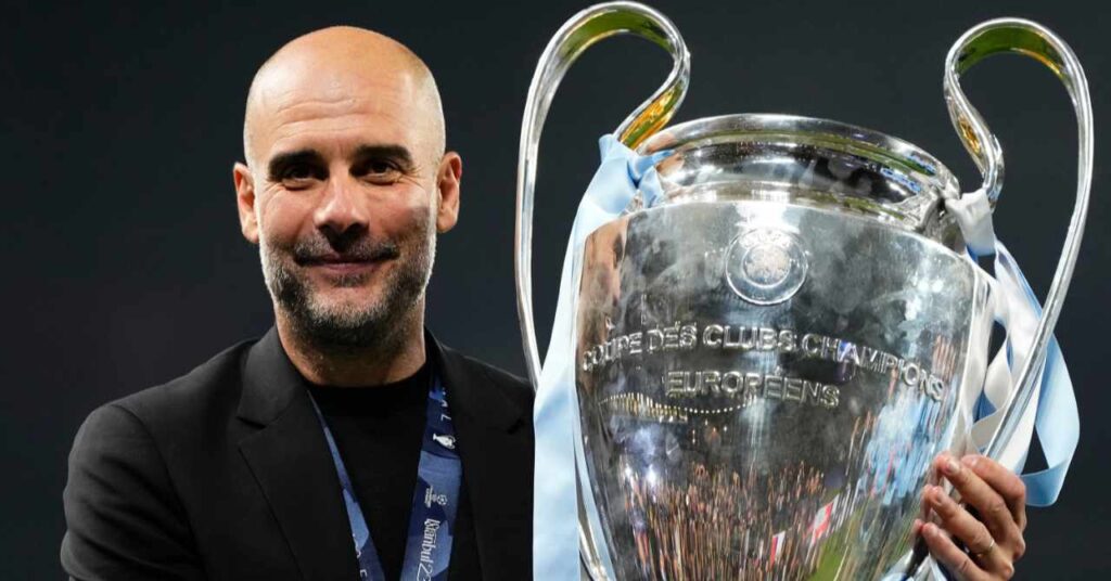 L'allenatore Pep Guardiola indossa un abito nero mentre tiene in mano il trofeo d'argento della UEFA Champions League vinto dal Manchester City in uno stadio e sorride nel suo ruolo di capo allenatore della squadra di Premier League del Manchester City Football Club.